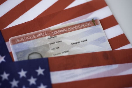 Employment Authorization card on USA Flag surface